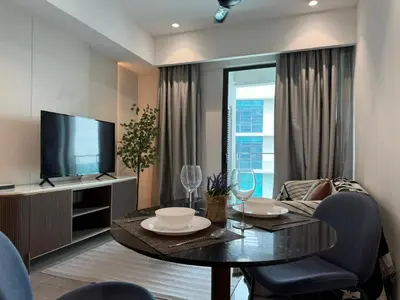 a living room with a table and a television at TheOoak 1BRoom cozyhome with balcony in Kuala Lumpur