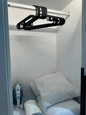 a shelf with a pillow and a fan in a room at TheOoak 1BRoom cozyhome with balcony in Kuala Lumpur
