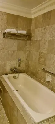 a bathroom with a white tub in a room at Soho Service Suite at Times Square KL in Kuala Lumpur