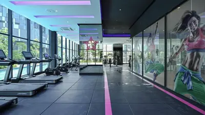 a gym with treadmills and a mural of a woman at Star Residence T1, 2br Unit Floor 36 in Kuala Lumpur