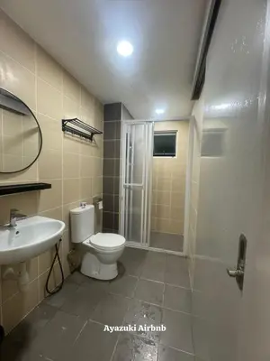 a bathroom with a toilet and a sink and a shower at Ayazuki Sky Suite KLCC View 2BR Free Parking Netflix Swimming Pool in Kuala Lumpur