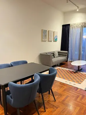 a living room with a table and chairs and a couch at Atmoods - The Mews KLCC in Kuala Lumpur