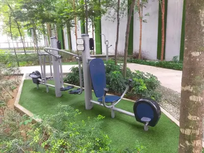 a group of exercise equipment in a park with trees at Mid Night Realm Kuala Lumpur in Kuala Lumpur