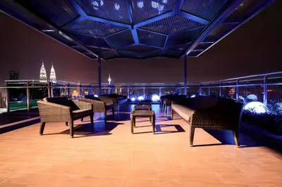a room with chairs and a couch and a table at Expressionz KLCC By Sky Homez in Kuala Lumpur
