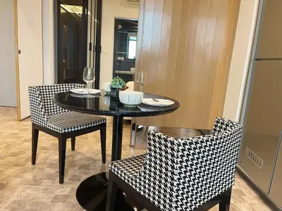 a dining room with a table and two chairs at Expressionz KLCC By Sky Homez in Kuala Lumpur