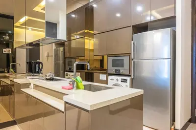 a large kitchen with a stainless steel refrigerator at Dorsett Residence Kuala Lumpur 8 pax in Kuala Lumpur