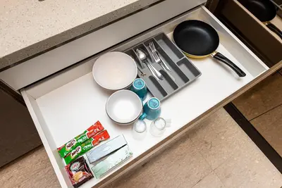 a counter top with bowls and utensils on it at Dorsett Residence Kuala Lumpur 8 pax in Kuala Lumpur