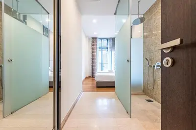 a bathroom with a shower and a glass door at Dorsett Residence Kuala Lumpur 8 pax in Kuala Lumpur