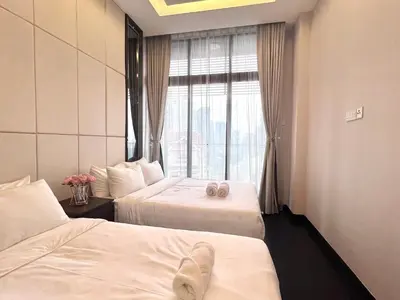 a hotel room with two beds and a window at Dorsett Residence Kuala Lumpur 8 pax in Kuala Lumpur