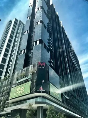 a tall building with a sign on the side of it at Mcity Residence way to KLCC in Kuala Lumpur