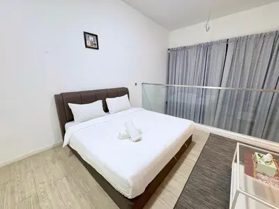 a bedroom with a large white bed with a window at Mcity Residence way to KLCC in Kuala Lumpur