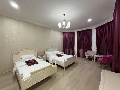 a bedroom with two beds and purple curtains at Titiwangsa Premium Villa KL by uBook in Kuala Lumpur