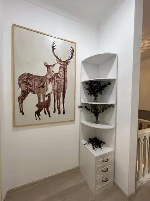 a picture of two deer on a wall next to a shelf at Titiwangsa Premium Villa KL by uBook in Kuala Lumpur