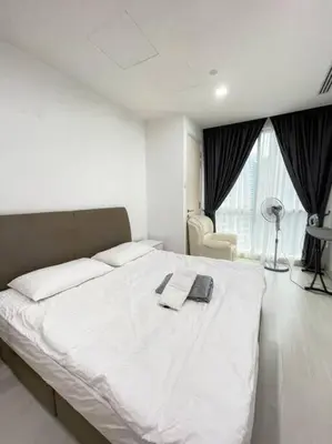 a bedroom with a white bed with two towels on it at Binjai 8 Soho Premium Near KLCC & LRT KLCC in Kuala Lumpur