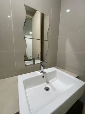 a bathroom with a white sink and a mirror at Binjai 8 Soho Premium Near KLCC & LRT KLCC in Kuala Lumpur