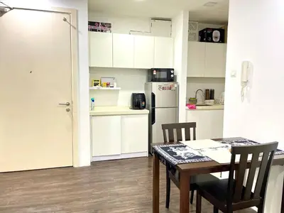 a kitchen with a table and chairs and a refrigerator at Binjai 8 Soho Premium Near KLCC & LRT KLCC in Kuala Lumpur