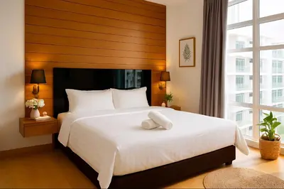 a bedroom with a large white bed with a large window at KL Sentral Dua Sentral Cozy Homestay Apartments by Hollywood Homes #FreeCarPark in Kuala Lumpur