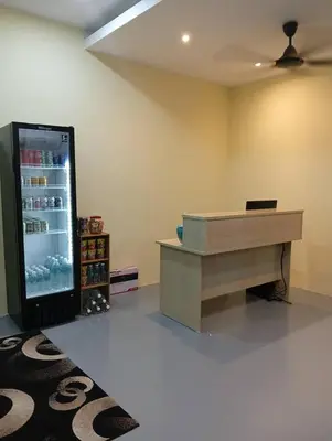 a room with a large refrigerator and a desk at Monkey Mansion Signature in Kuala Lumpur