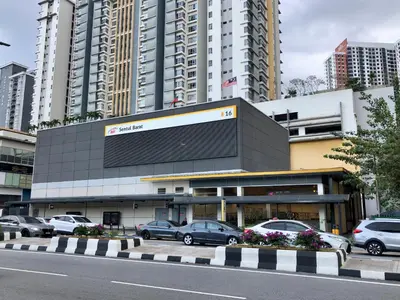 a building with cars parked in a parking lot at Monkey Mansion Signature in Kuala Lumpur