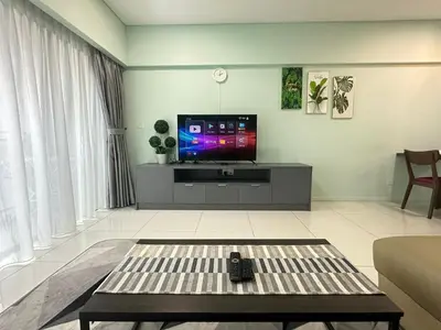 a living room with a tv and a couch at Summer Suites KLCC By CityHomes in Kuala Lumpur