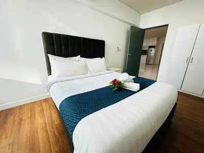 a hotel room with a large bed with flowers on it at Summer Suites KLCC By CityHomes in Kuala Lumpur