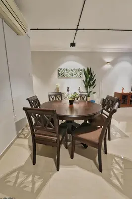 a dining room with a wooden table and chairs at Bukit Bintang Pavilion KLCC Wisma Cosway in Kuala Lumpur