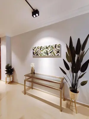 a living room with a bench and a plant at Bukit Bintang Pavilion KLCC Wisma Cosway in Kuala Lumpur