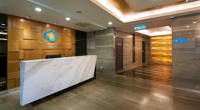 a lobby with a large marble counter in a building at Hotel Transit Kuala Lumpur in Kuala Lumpur