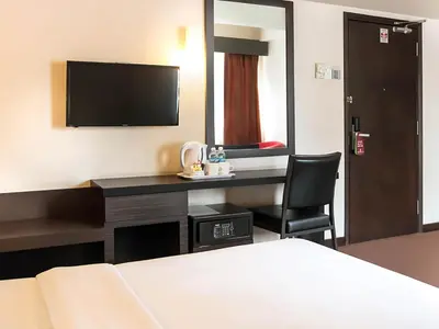 a hotel room with a desk and a television at Hotel Summer View in Kuala Lumpur