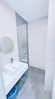 a white bathroom with a sink and a mirror at KLCC sky view 1BR luxury suites with Balcony Trion A5507 KL in Kuala Lumpur