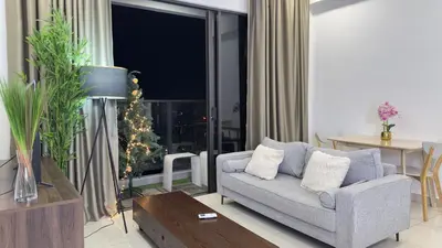 a living room with a couch and a christmas tree at KLCC sky view 1BR luxury suites with Balcony Trion A5507 KL in Kuala Lumpur