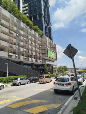 a parking lot with cars parked in front of a building at M City Ampang By Klcc View in Kuala Lumpur