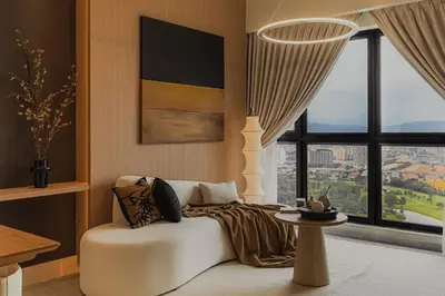a living room with a white couch and a window at NaiBnB in Agile Bukit Bintang - 5 mins walk to TRX in Kuala Lumpur
