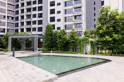 a swimming pool in front of a tall building at NaiBnB in Agile Bukit Bintang - 5 mins walk to TRX in Kuala Lumpur