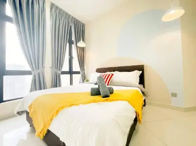 a bedroom with a large bed with a yellow blanket at Cheras KL Premium 3B2B by Luvit Stay in Kuala Lumpur
