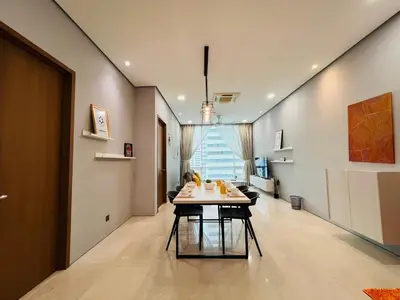 a dining room with a table in the middle of a room at Soho Suites KLCC by DeUrban in Kuala Lumpur
