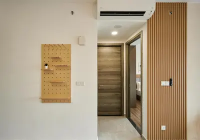 a hallway with white walls and a wooden door at Ayatt Bukit Bintang in Kuala Lumpur