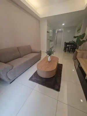 a living room with a couch and a coffee table at Muji Themed Apartment by Zen Sojourn - Opposite KL SENTRAL in Kuala Lumpur