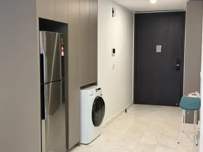 a kitchen with a refrigerator and a washing machine at Eaton Residence Klcc By Apple in Kuala Lumpur