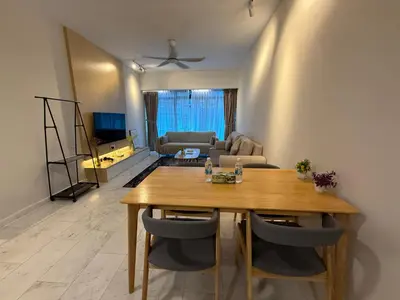 a living room with a wooden table and a couch at Eaton Residence Klcc By Apple in Kuala Lumpur