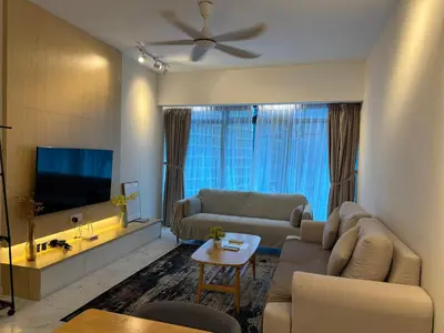 a living room with a couch and a flat screen tv at Eaton Residence Klcc By Apple in Kuala Lumpur
