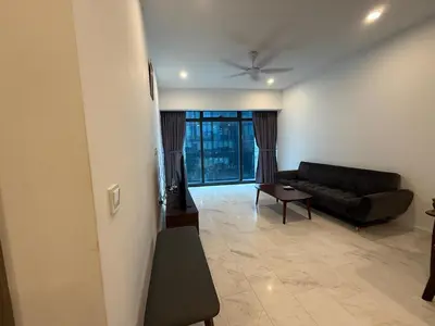 a living room with a couch and a table at Eaton Residence Klcc By Apple in Kuala Lumpur