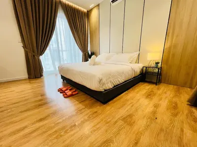 a bedroom with a bed and a wooden floor at Quill Residence KL by DeUrban in Kuala Lumpur