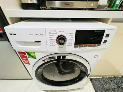 a washing machine with a microwave on top of it at Quill Residence KL by DeUrban in Kuala Lumpur