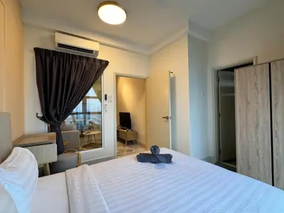 a bedroom with a bed with a teddy bear on it at Arte mont kiara by Sweet home in Kuala Lumpur