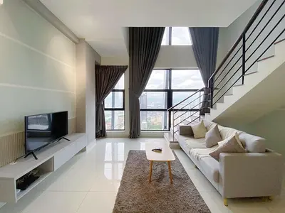 a living room with a couch and a tv at Arte mont kiara by Sweet home in Kuala Lumpur