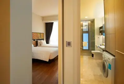 a hotel room with a bed and a bathroom at The Signature Hotel & Serviced Suites Hartamas Kuala Lumpur in Kuala Lumpur