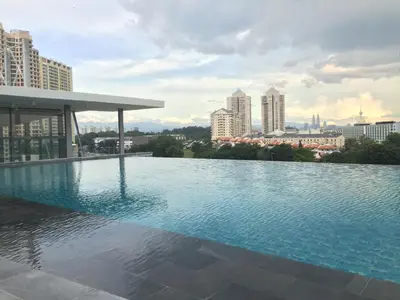a swimming pool on the roof of a building with a city at The Signature Hotel & Serviced Suites Hartamas Kuala Lumpur in Kuala Lumpur