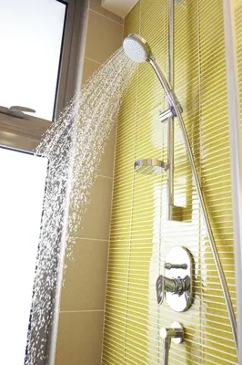 a shower in a bathroom with water pouring out at The Signature Hotel & Serviced Suites Hartamas Kuala Lumpur in Kuala Lumpur