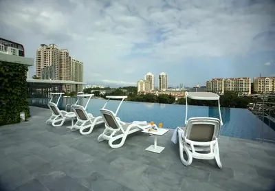 a group of white chairs sitting on a roof at The Signature Hotel & Serviced Suites Hartamas Kuala Lumpur in Kuala Lumpur